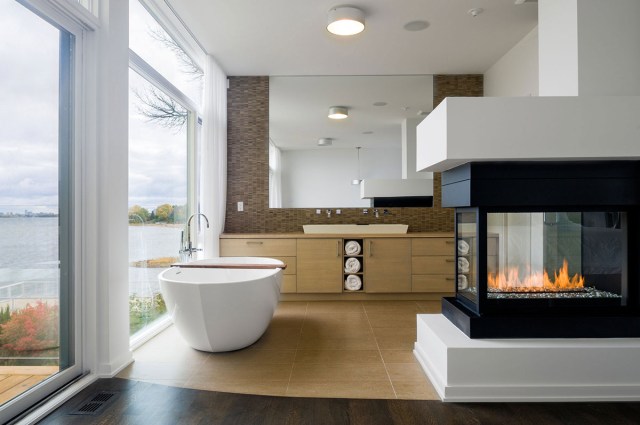soaking in the tub by a warm glowing flame of a modern fireplace is a pretty nice way to end a day